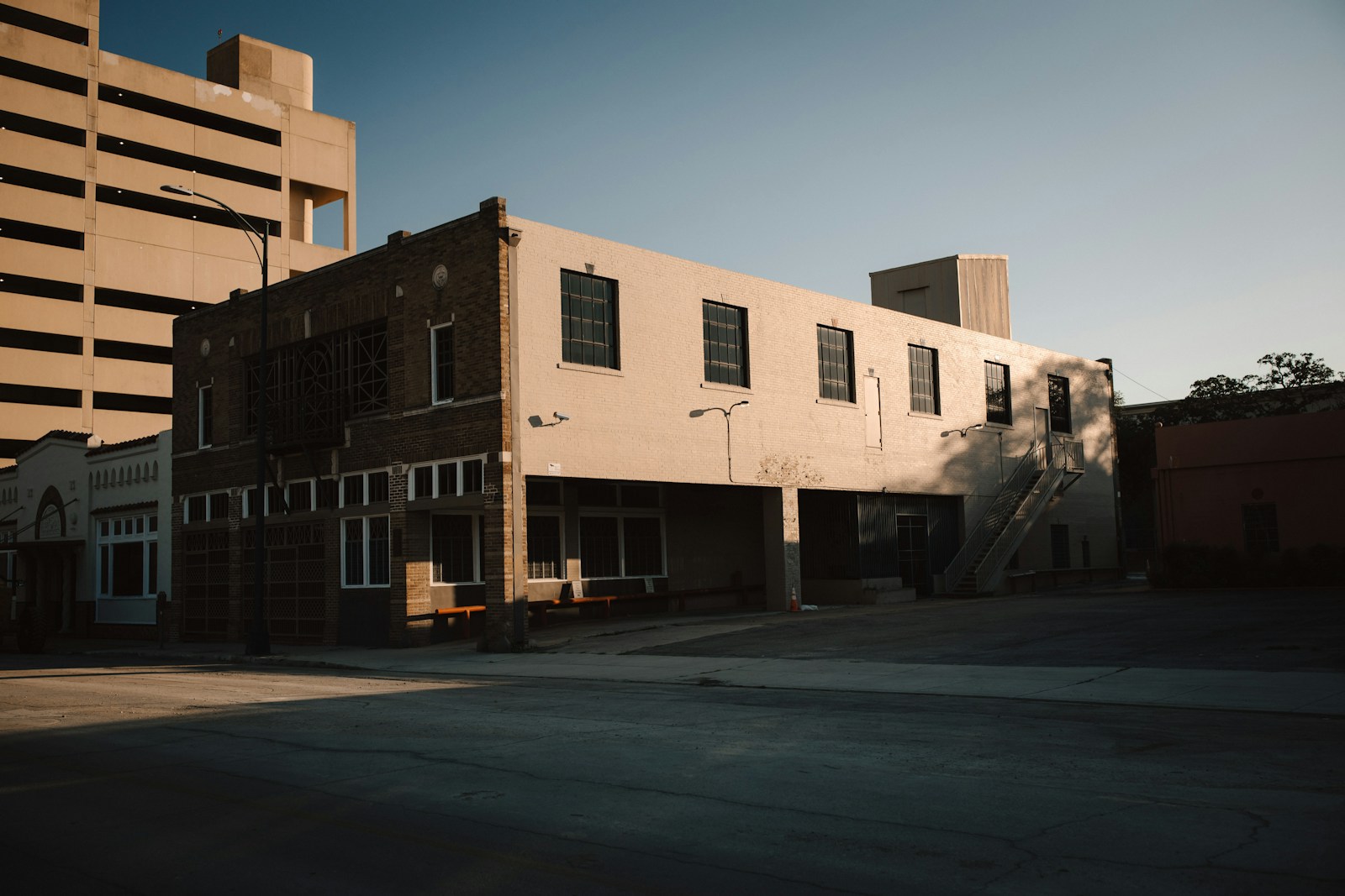 an empty street in front of a tall building
